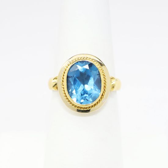 Picture of 18k Yellow Gold & Bezel Set Oval Cut Blue Topaz Ring