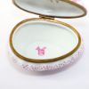 Picture of Retired Limoges Porcelain Rabbits Sleeping in Pink Egg Shaped Bed Trinket Box